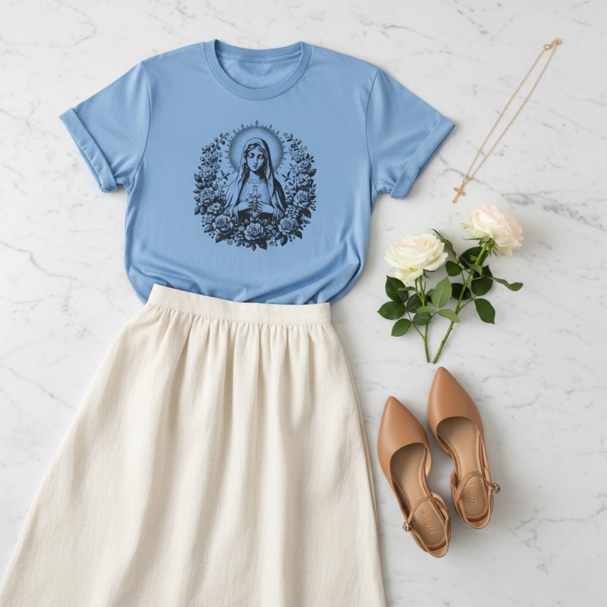 Light blue women’s t-shirt featuring a vintage floral Virgin Mary illustration — elegant Marian apparel for women of faith.